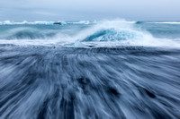 wave wash on a black sand beach