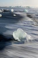 wave wash motion on a black sand beach